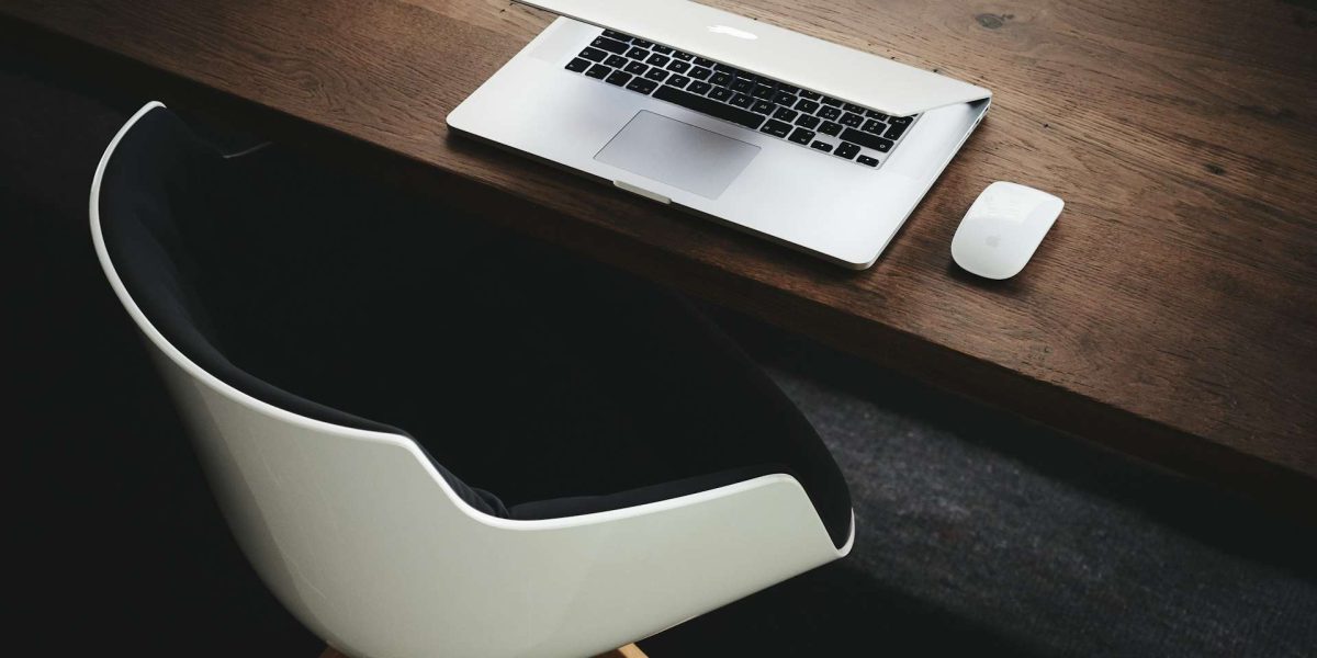 Apple MacBook beside computer mouse on table